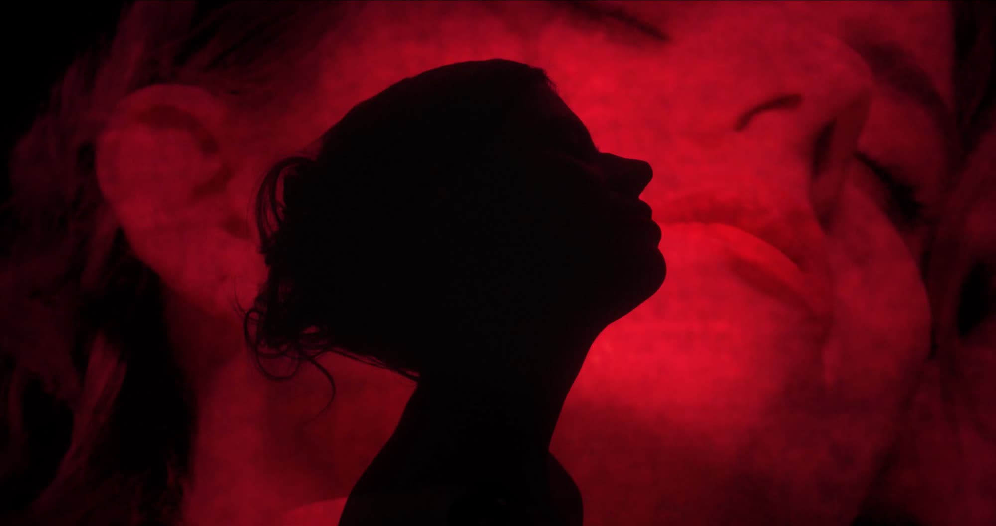 Ater music video still - split composition, red silhouette profile beside a romantic close-up