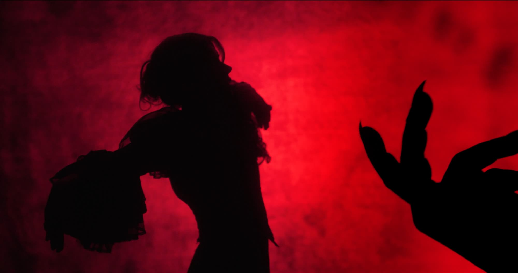 Ater music video still - full band performing in fog, bassist singing into a boom mic
