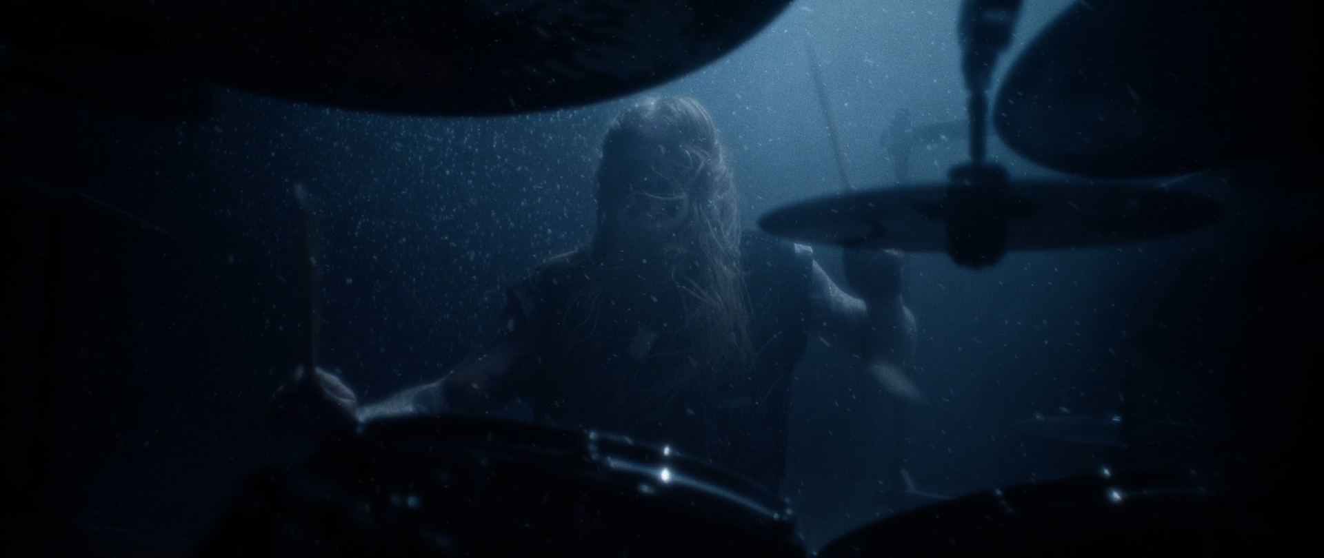 Behemoth Mystic still - drummer performing behind cymbals in dense blue fog, ash drifting past