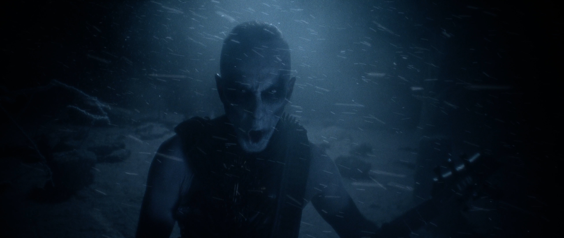 Behemoth Mystic still - corpsepainted figure screaming toward the camera in a blue snowstorm