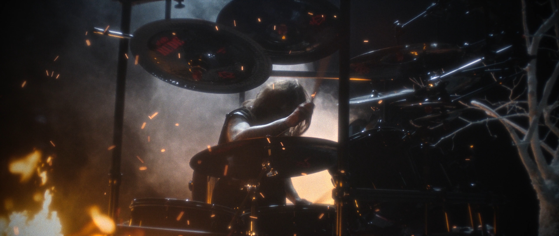 Behemoth Mystic still - drummer silhouetted amid flames, sparks and bare branches