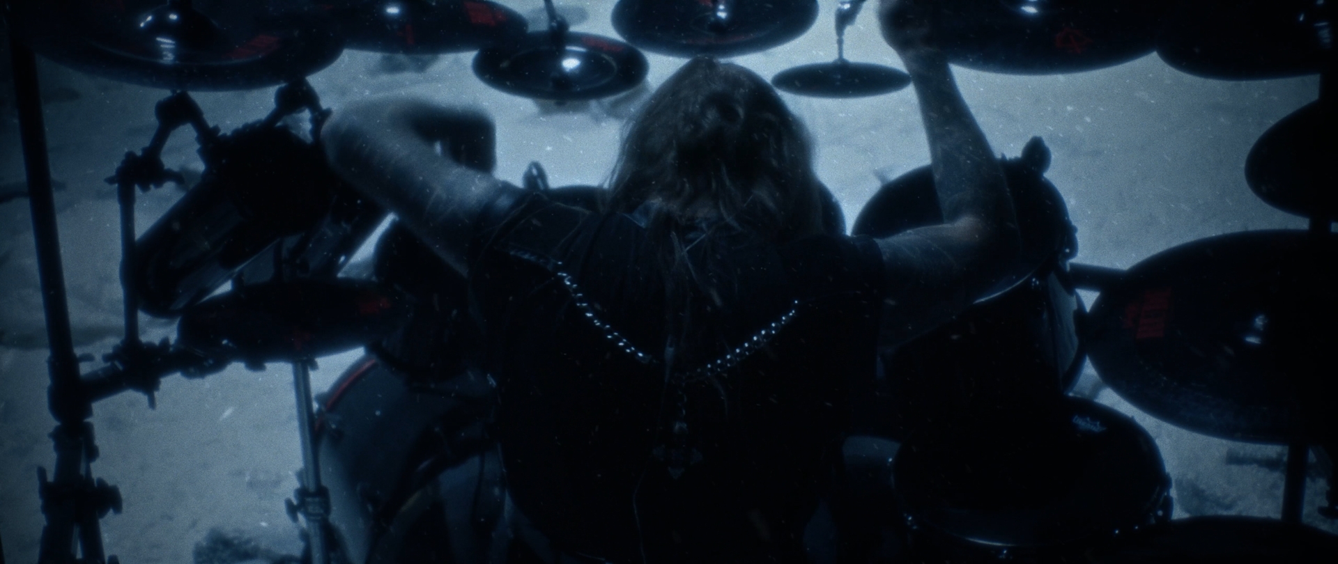 Behemoth Mystic still - overhead shot of a drummer surrounded by cymbals, snow visible below