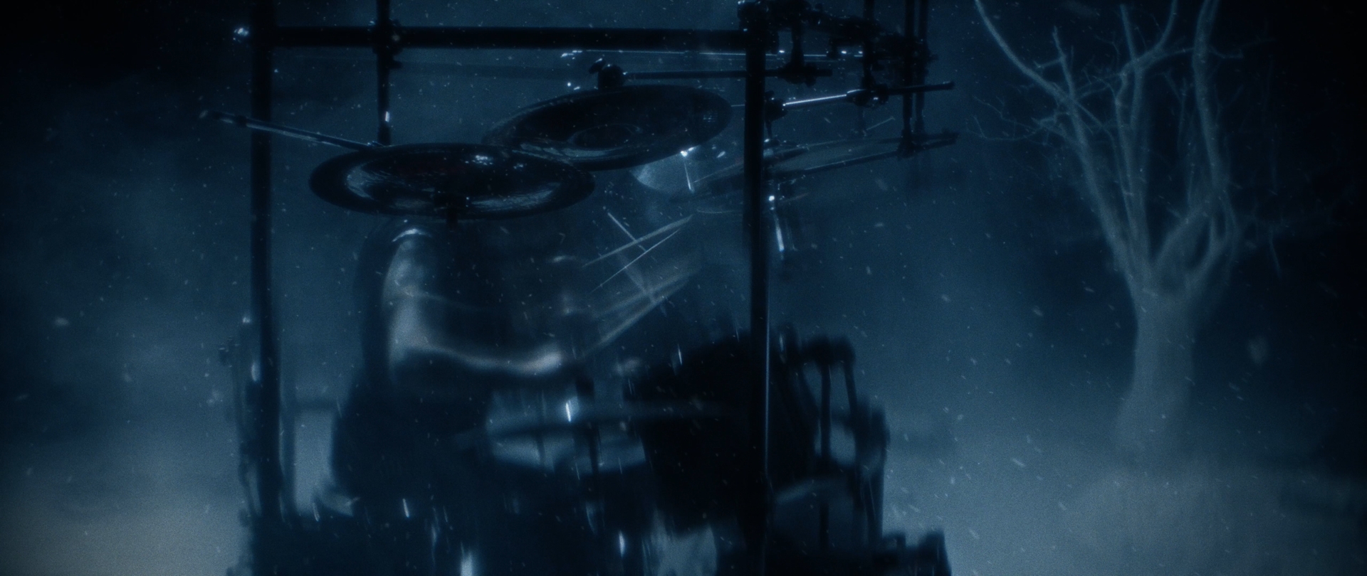 Behemoth Mystic still - drum kit silhouetted in blue fog beside a bare winter tree