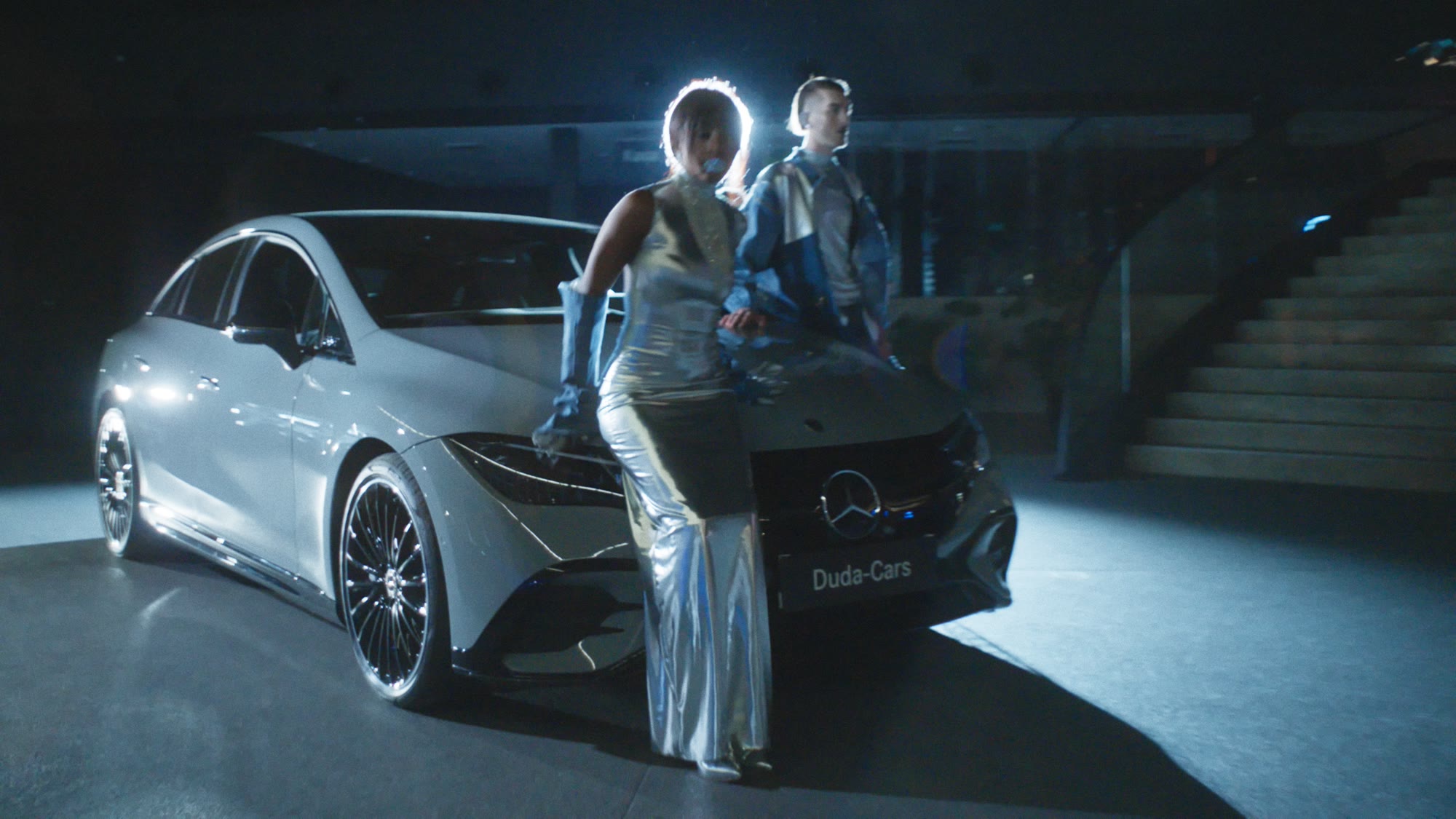 Two models beside car headlights at night - Wrocław Fashion Week