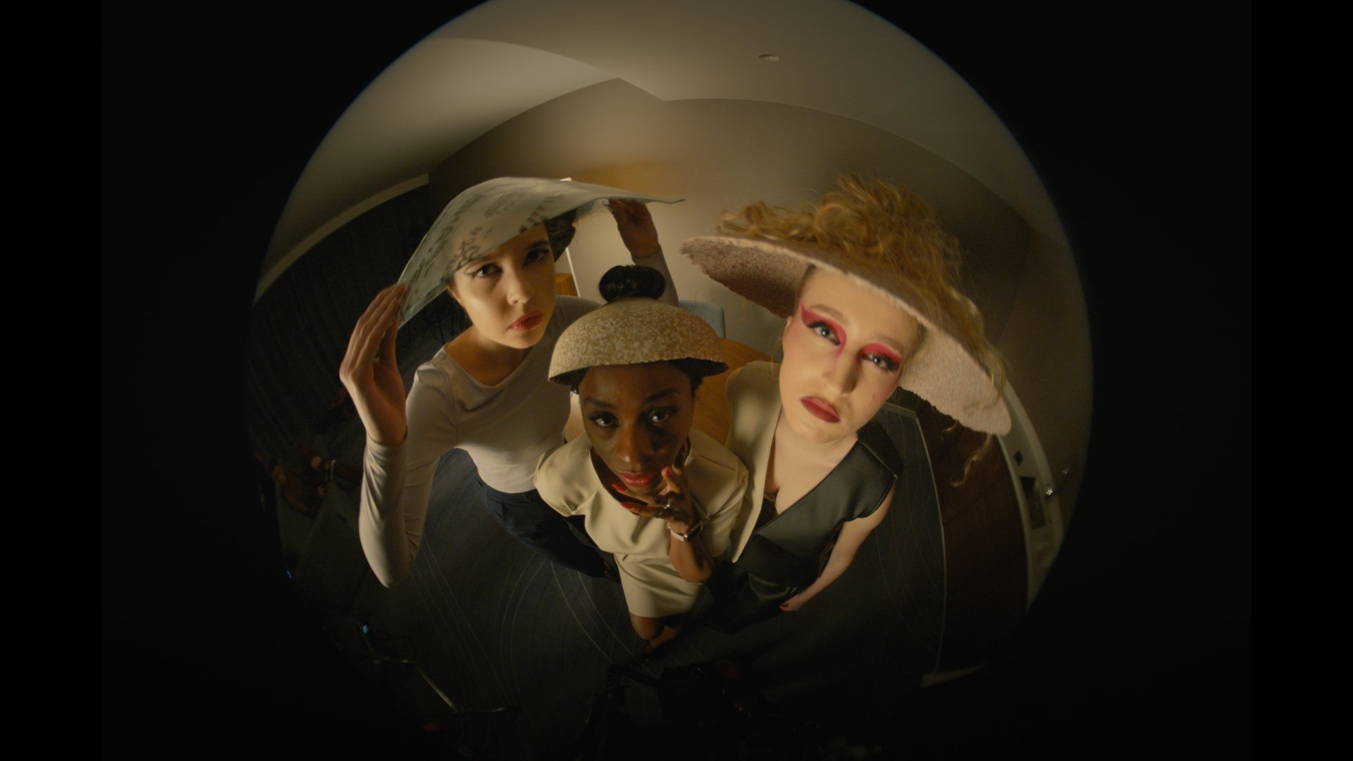 Three masked, costumed figures pressed close together, shot on a fisheye lens - Wrocław Fashion Week 2025