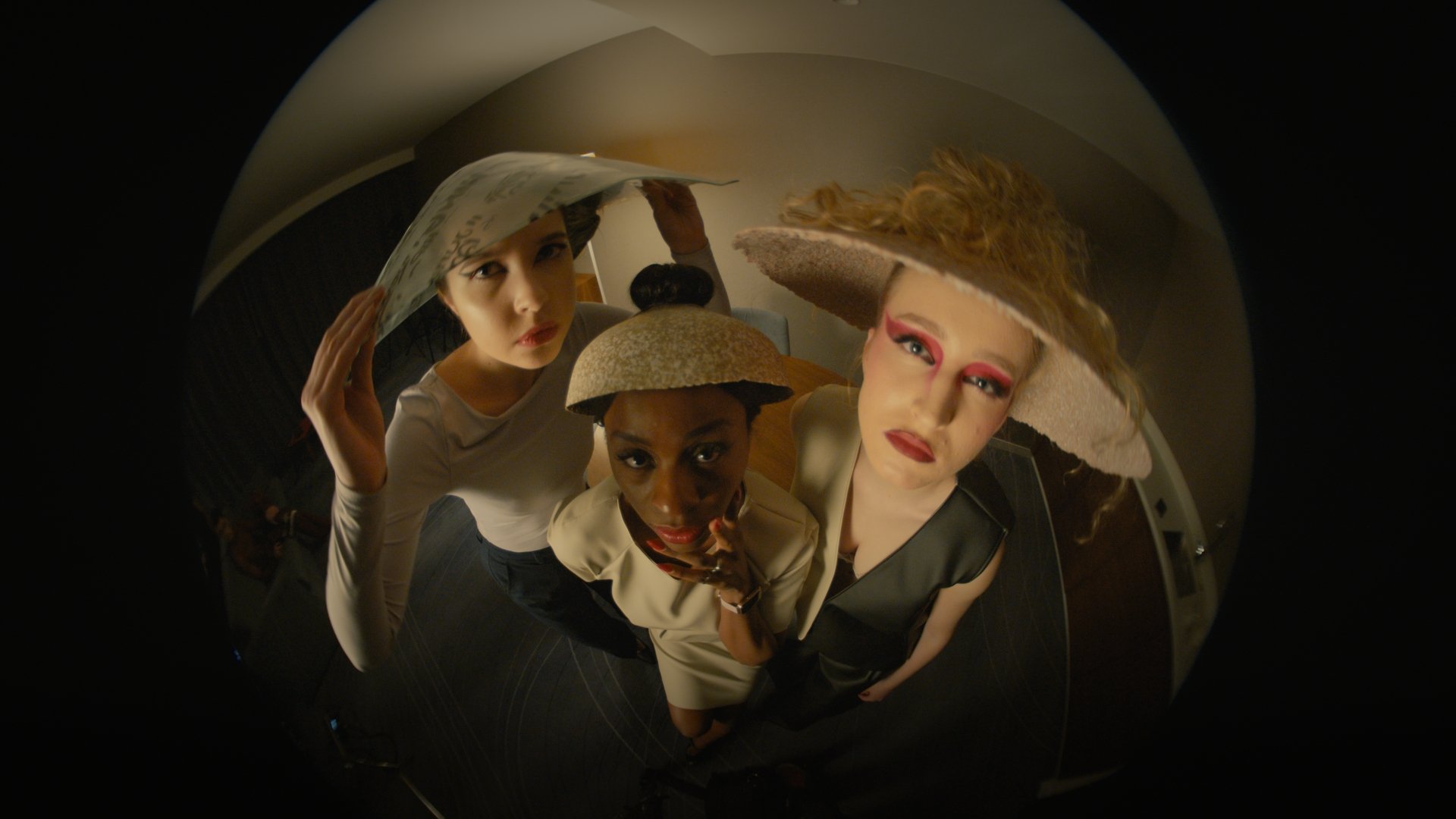 Three masked, costumed figures on a fisheye lens, wider framing - Wrocław Fashion Week 2025