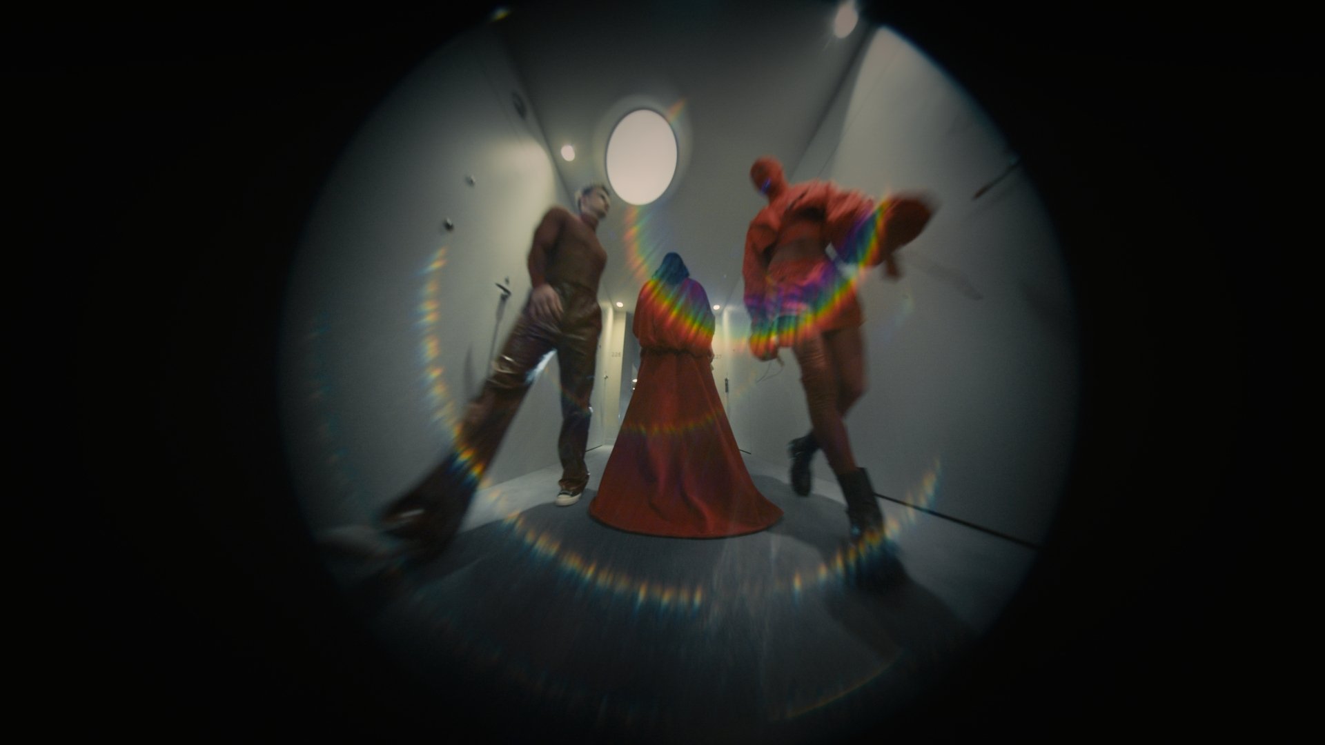Fisheye shot of a figure in a rainbow feathered costume - Wrocław Fashion Week 2025
