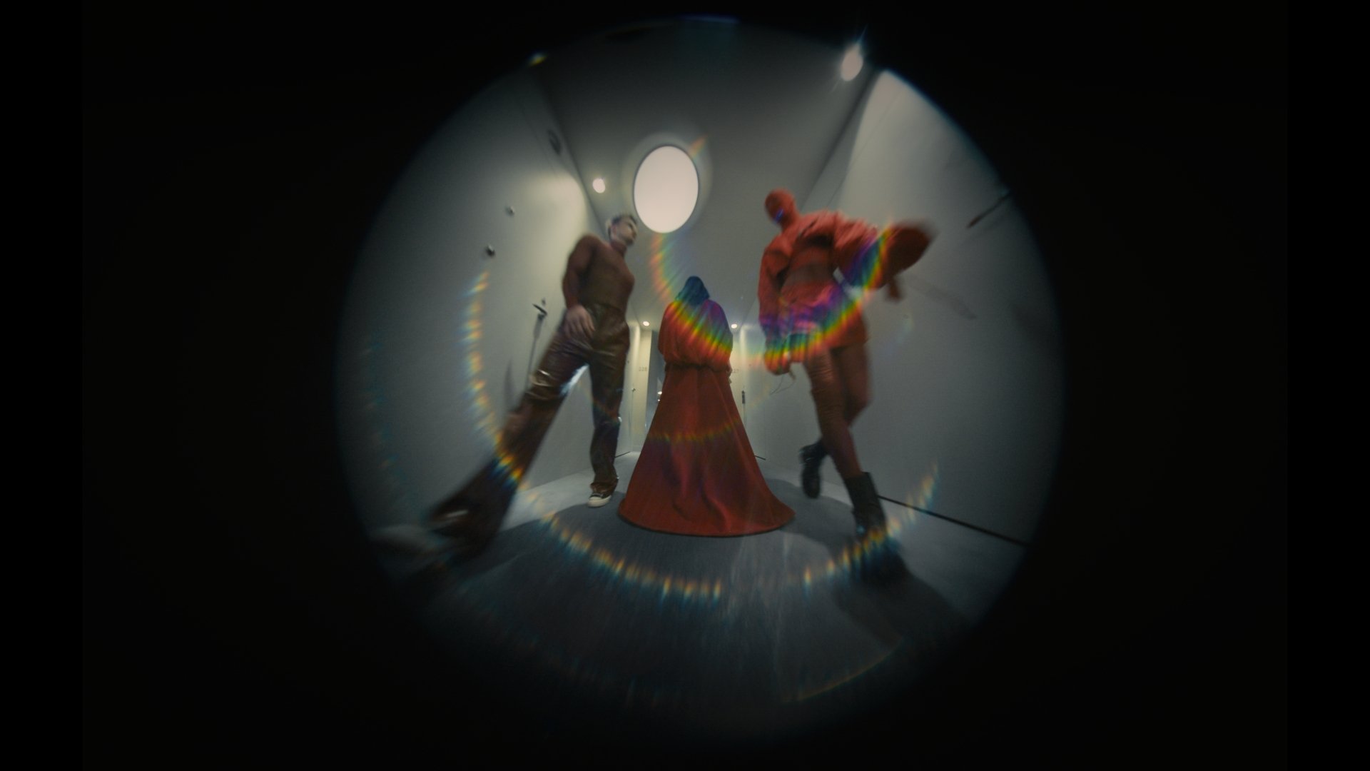 Fisheye shot of a figure in a rainbow feathered costume, alternate angle - Wrocław Fashion Week 2025