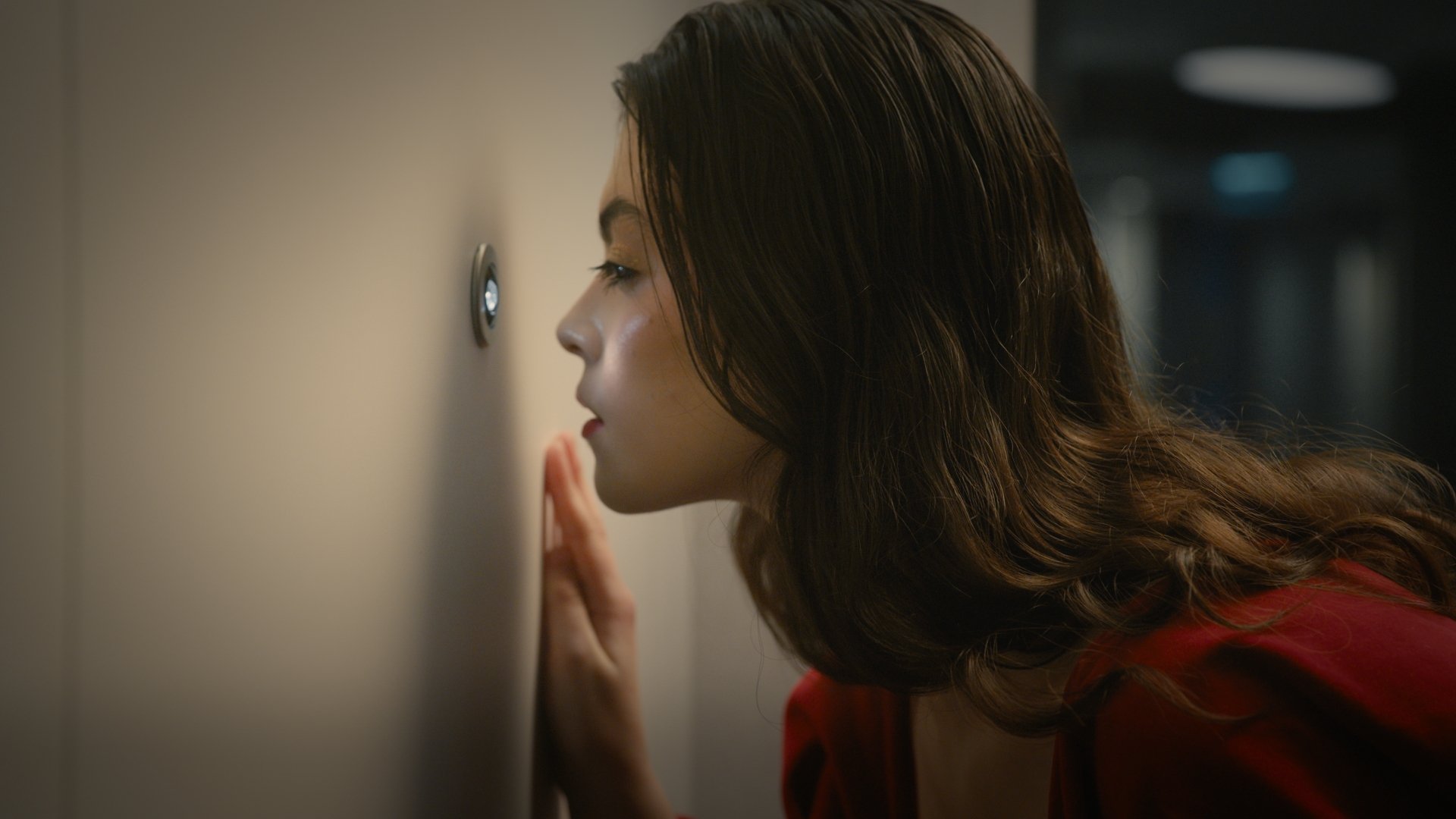 Close profile of a woman peering around a doorway - Wrocław Fashion Week 2025