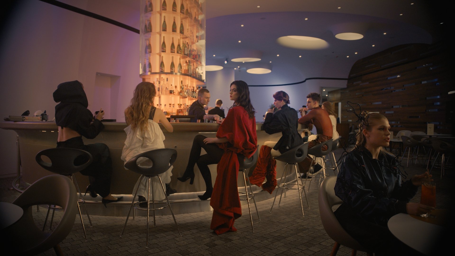 Wide shot of a group gathered in a lounge at night - Wrocław Fashion Week 2025