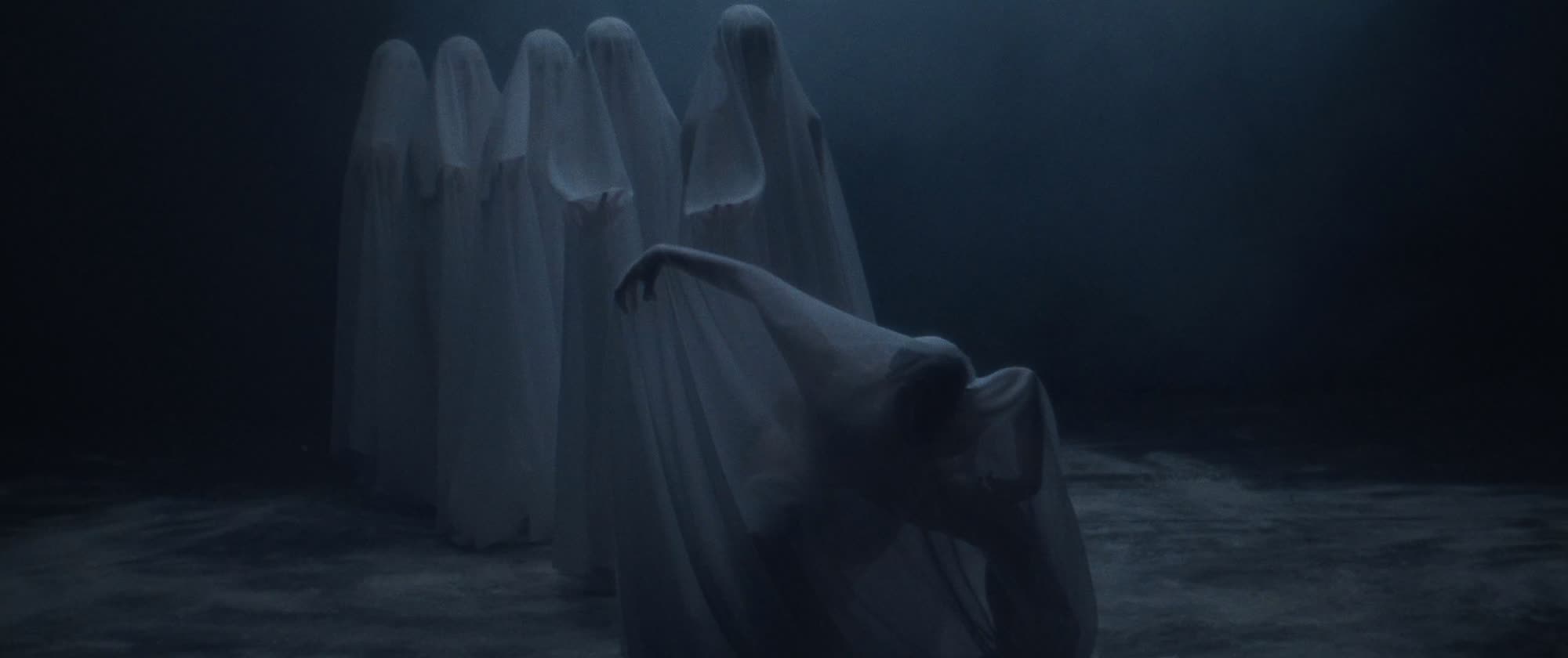 IGORRR music video still - group of shrouded ghost-like figures in blue fog