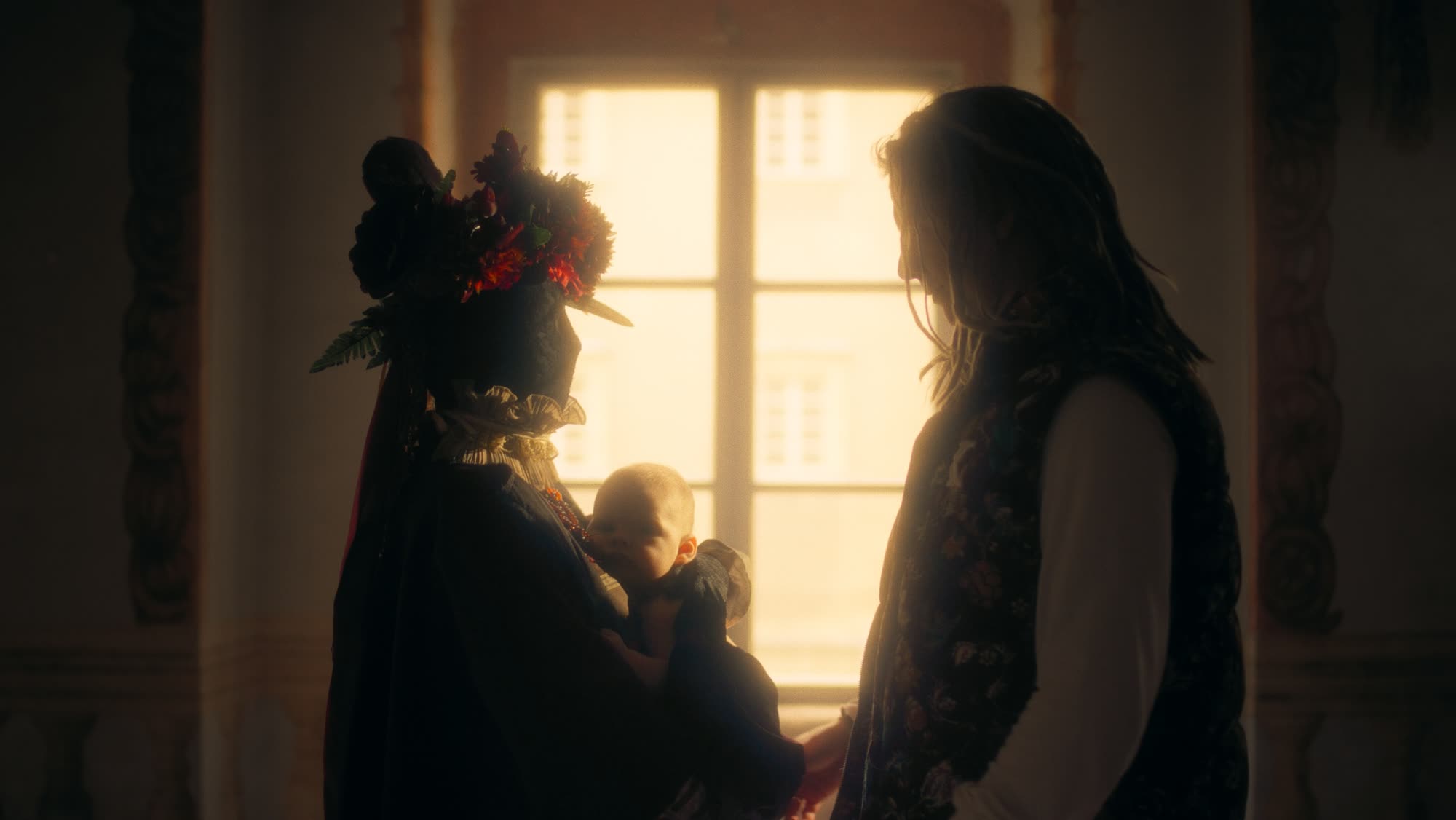 Jestem Alpha still - close portrait in a red floral folk headdress with ribbons