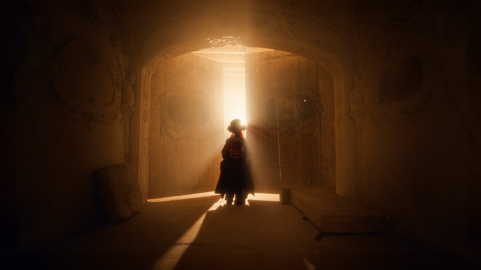 Jestem Alpha still - figure in a floral folk headdress standing in a sunlit doorway