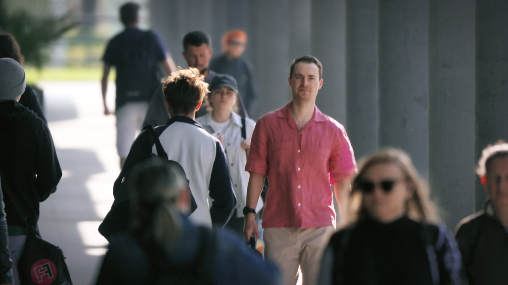 People walking across a modern city plaza - Miastolas commercial