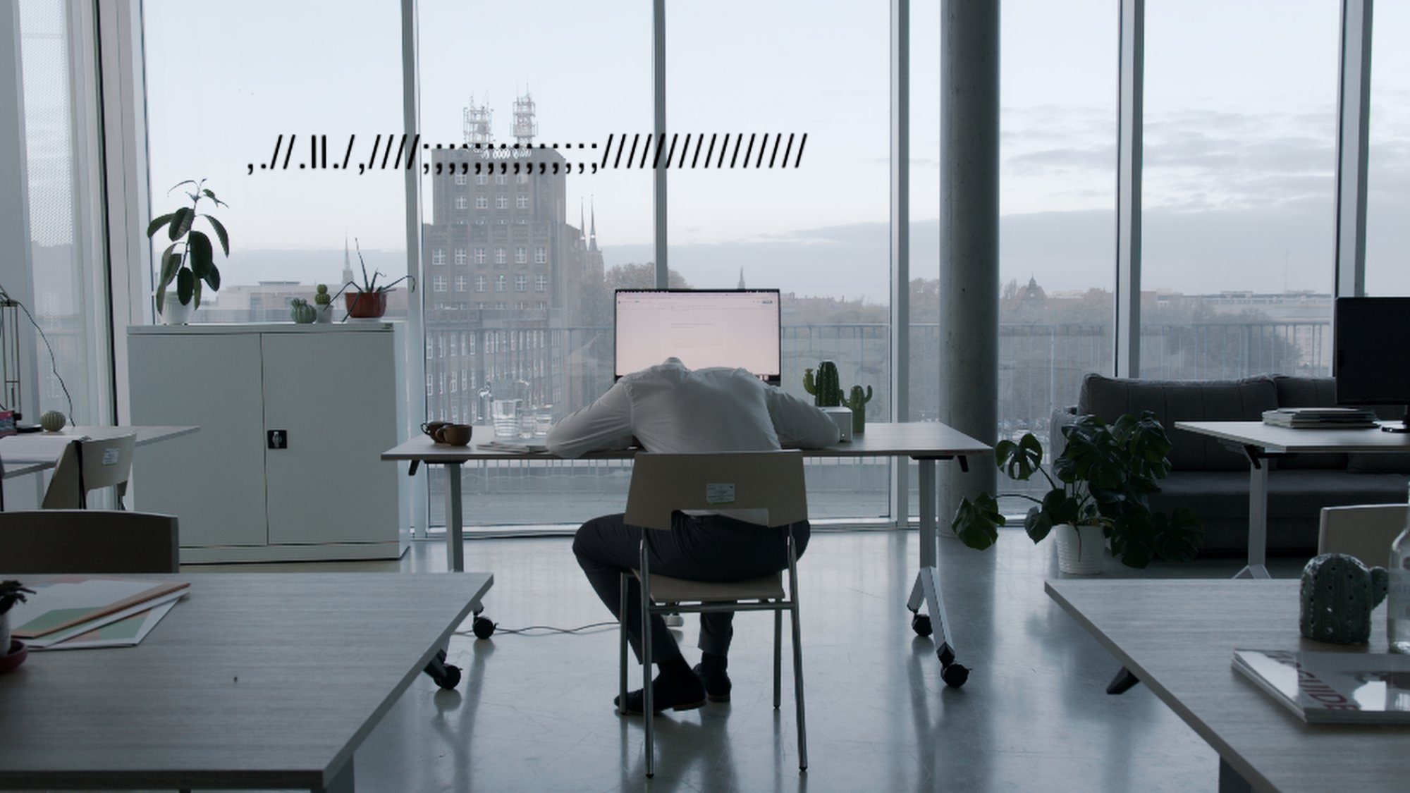 Wide shot of an empty modern office at dusk, city lights beyond the windows - Plantpur commercial