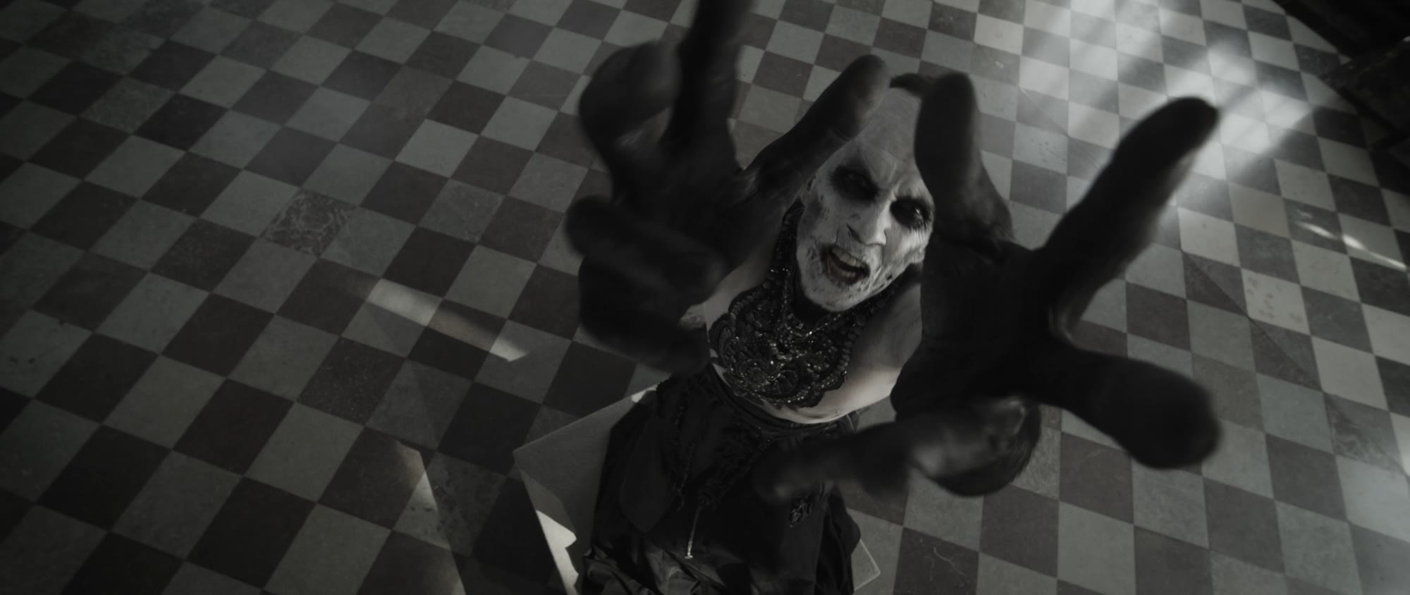 Behemoth music video still - hands reaching toward the camera in motion blur