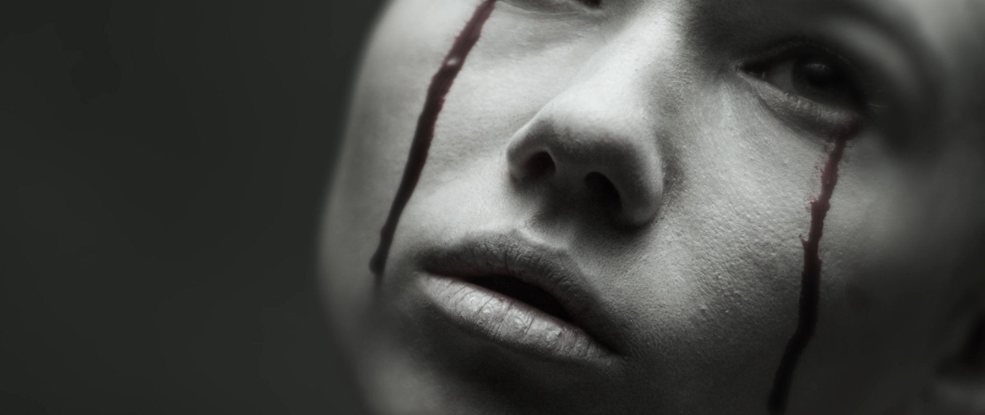 Behemoth music video still - close-up of a woman's distressed face