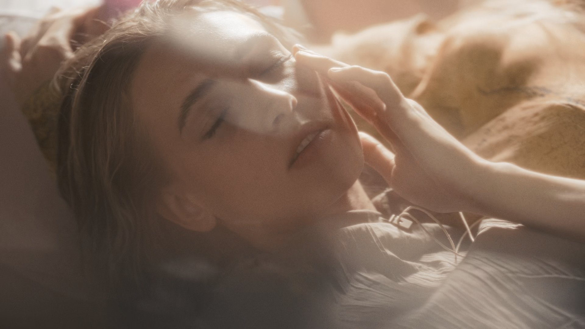 Close-up of a model reclining, eyes closed, soft light across her face and shoulder - Wrocław Fashion Week Collections