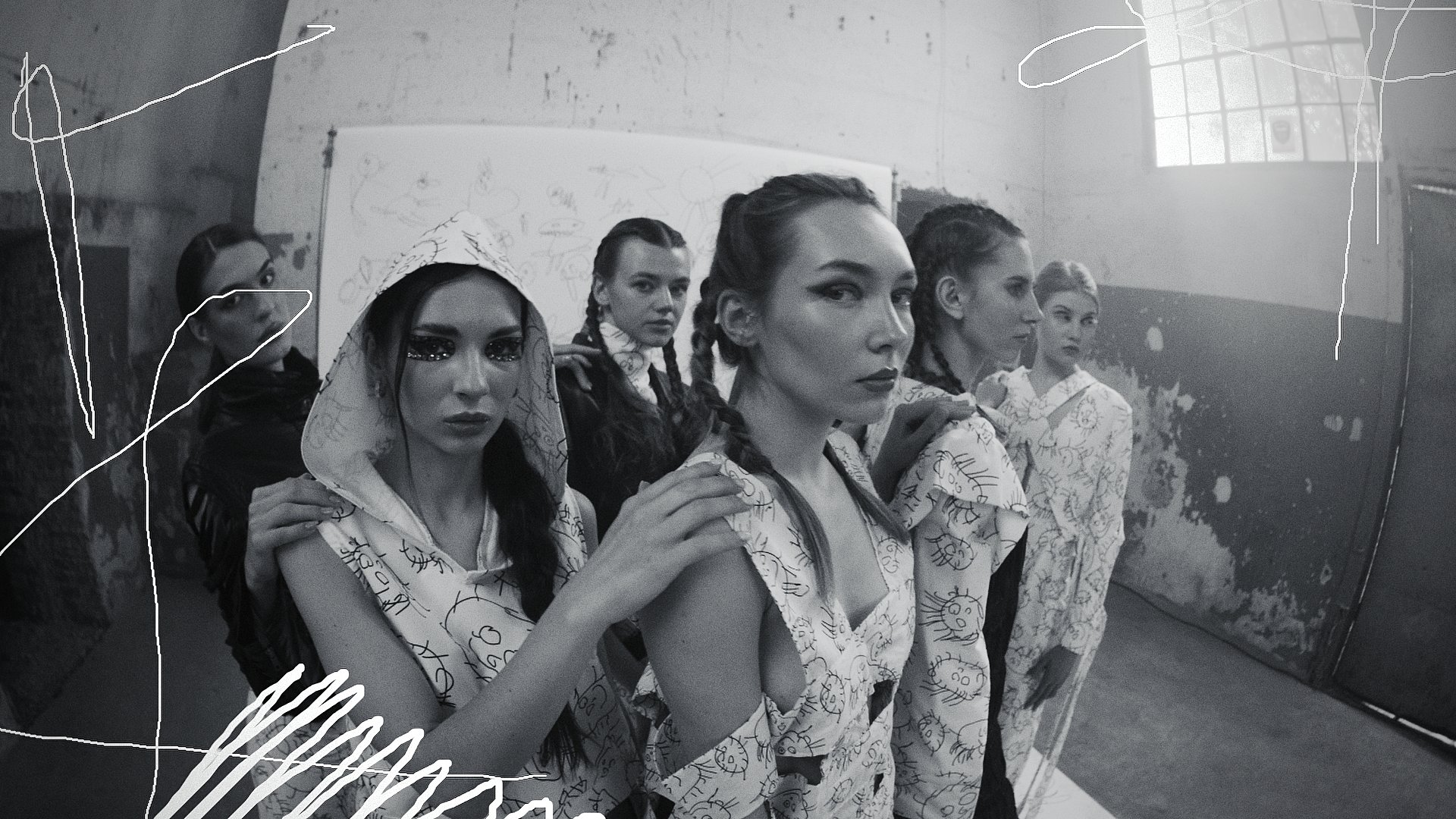 Black and white group portrait of models in patterned dresses with a sketched illustration overlay - Wrocław Fashion Week Collections
