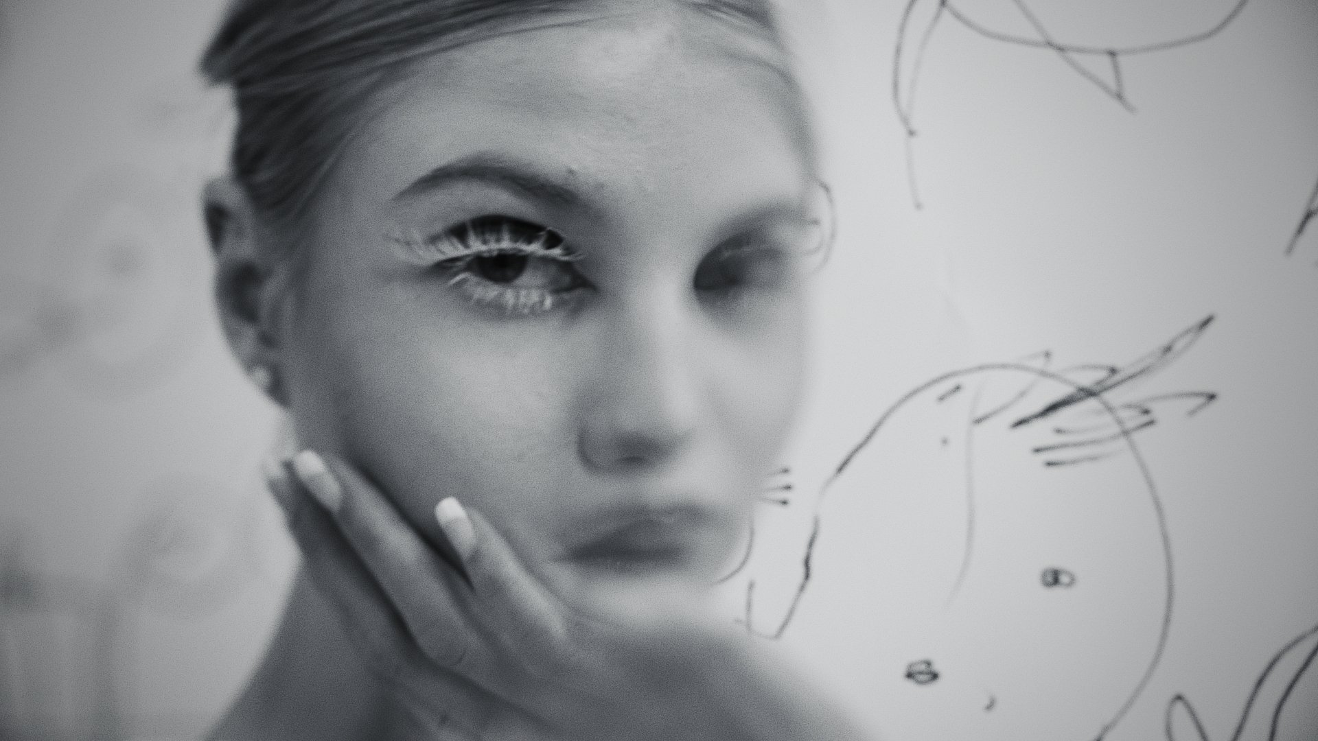 Black and white close-up portrait, hand near the chin, sketch marks overlaid - Wrocław Fashion Week Collections