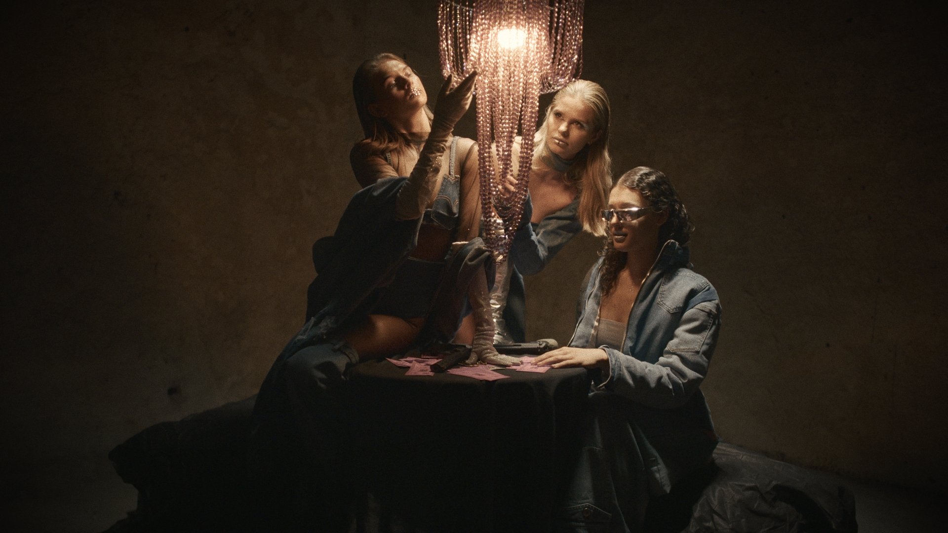 Group gathered around a candlelit table - Wrocław Fashion Week Collections